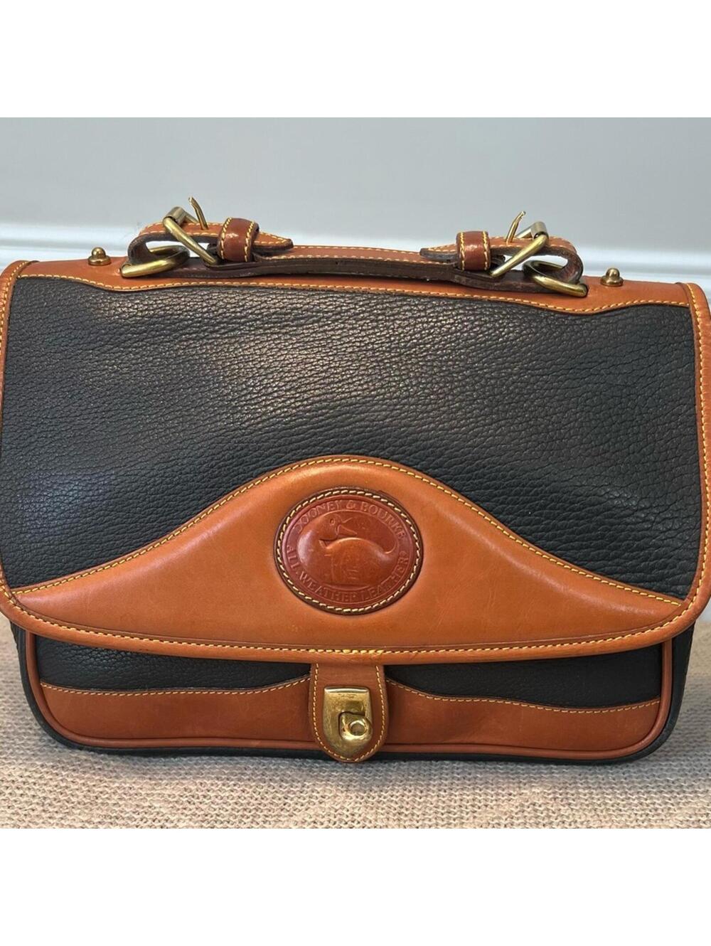 Dooney and Bourke Elegant Black and Tan Leather Shoulder Bag